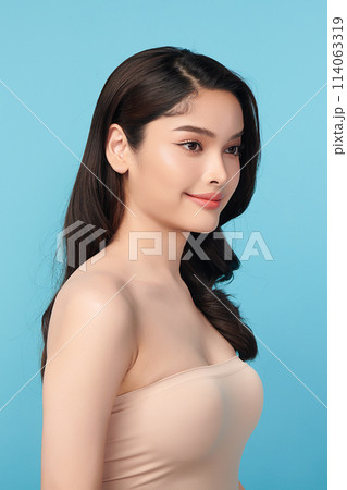 Beautiful Young transgender woman with clean fresh skin on blue background, Face care, Facial treatment, Cosmetology, beauty and spa, transgender women portrait. Beautiful Young transgender woman with clean fresh skin on blue background, Face care, Facial treatment, Cosmetology, beauty and spa, transgender women portrait. 114063319
