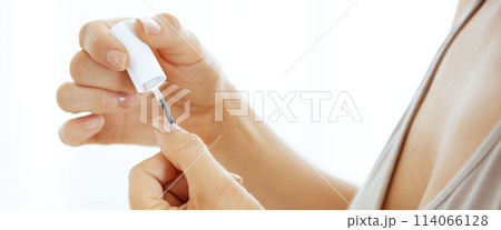 Closeup on young woman applying nail polish 114066128