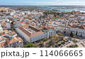 Traditional Portuguese town of Faro on oceanfront with old architecture, filmed by drone. Ria formosa in background. 114066665