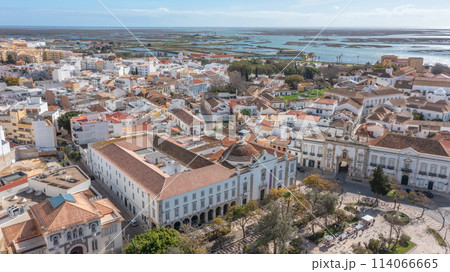 Traditional Portuguese town of Faro on oceanfront with old architecture, filmed by drone. Ria formosa in background. 114066665