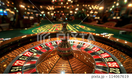 Close-Up View of a Casino Roulette Wheel in Action During Evening Gameplay Close-Up View of a Casino Roulette Wheel in Action During Evening Gameplay 114067619