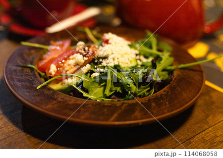 salad with fresh vegetables, greens and brynza cheese on a plate salad with fresh vegetables, greens and brynza cheese on a plate 114068058