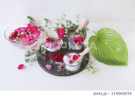 Spa still life with rose petals, salt and flowers on a white background Spa still life with rose petals, salt and flowers on a white background 114068834