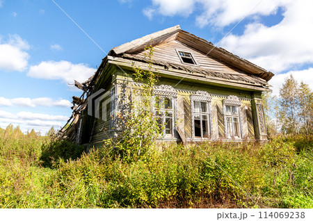 Abandoned destroyed rural wooden house in russian village in summer Abandoned destroyed rural wooden house in russian village in summer 114069238