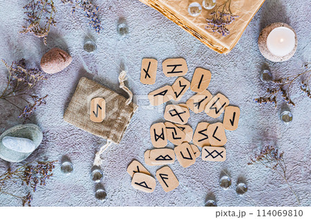 Scandinavian runes for fortune telling made of cardboard on the table next to the bag top view Scandinavian runes for fortune telling made of cardboard on the table next to the bag top view 114069810