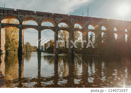 Railway Bridge with river in Bietigheim-Bissingen, Germany. Autumn. Railway viaduct over the Enz River, built in 1853 by Karl von Etzel on a sunny summer day. Bietigheim-Bissingen, Germany. Old Railway Bridge with river in Bietigheim-Bissingen, Germany. Autumn. Railway viaduct over the Enz River, built in 1853 by Karl von Etzel on a sunny summer day. Bietigheim-Bissingen, Germany. Old 114071037
