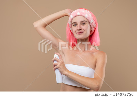 Smiling woman using antiperspirant after bathroom 114072756