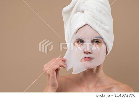 Attractive woman with cosmetic mask on face Attractive woman with cosmetic mask on face 114072770