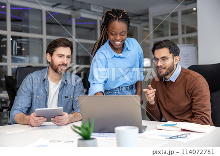 Happy businesspeople collaborating on new project in office 114072781