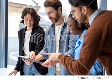 Diverse colleagues cooperating together at office Diverse colleagues cooperating together at office 114072827
