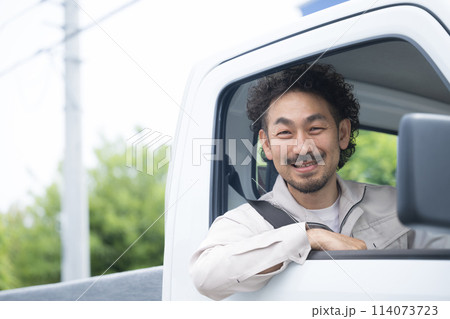 転職や求人に使いやすいトラックを運転する中年の作業着のガテン系の男性 カメラ目線 運送や配送業 転職や求人に使いやすいトラックを運転する中年の作業着のガテン系の男性 カメラ目線 運送や配送業 114073723