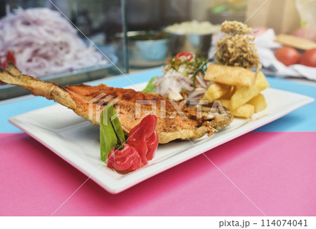 PERUVIAN FOOD, typical dish Fried trout, with rice, yucca and salad, Sective Focus PERUVIAN FOOD, typical dish Fried trout, with rice, yucca and salad, Sective Focus 114074041