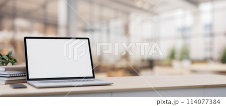 A laptop on a table with a blurred background of a spacious luxurious cafe coffee shop or restaurant A laptop on a table with a blurred background of a spacious luxurious cafe coffee shop or restaurant 114077384
