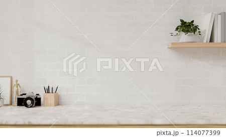 A display space on a white marble table showcases products against the white brick wall. 114077399