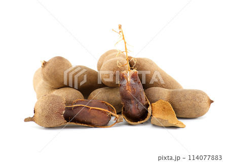 Tamarind whole and cracked open on white background 114077883