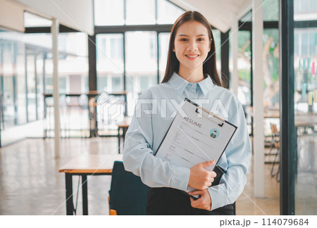 Asian young holding resume applying to apply for a job 114079684