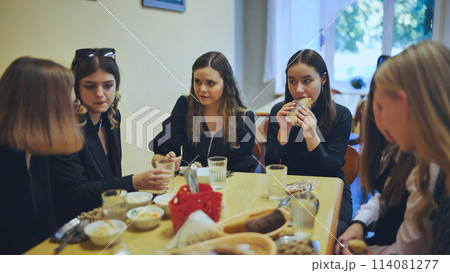 Senior girls having breakfast in the school canteen. 114081277
