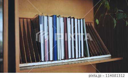 The teacher takes a school teacher's magazine from the shelf. 114081312