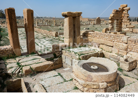 Round-shaped carved rock, Olive oil presses at archaeological site in roman ancient city Sufetula in Sbeitla in Tunisia Round-shaped carved rock, Olive oil presses at archaeological site in roman ancient city Sufetula in Sbeitla in Tunisia 114082449