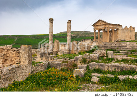Remains of Capitol Temple of Dougga in Tunisia under cloudy sky 114082453