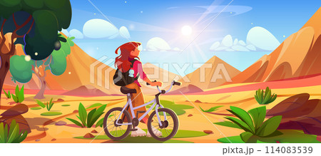 Female tourist with bicycle looking at sandy dunes 114083539