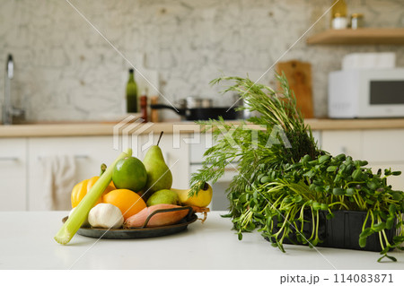 Fresh vegetables and fruits on a kitchen table Fresh vegetables and fruits on a kitchen table 114083871