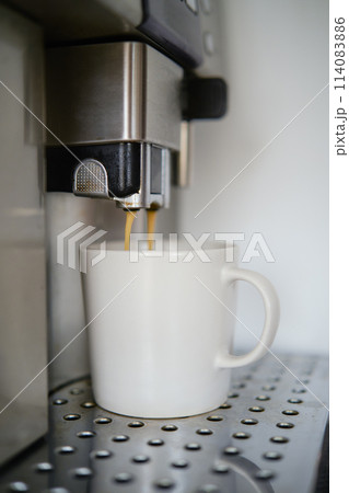 Close-up of espresso pouring from coffee machine Close-up of espresso pouring from coffee machine 114083886