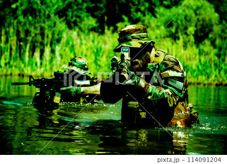 Soldiers move in the heart of a marsh, crossing swampy waters, tropical jungle heat, extreme conditions of concealed tactical combat operations of special task forces 114091204