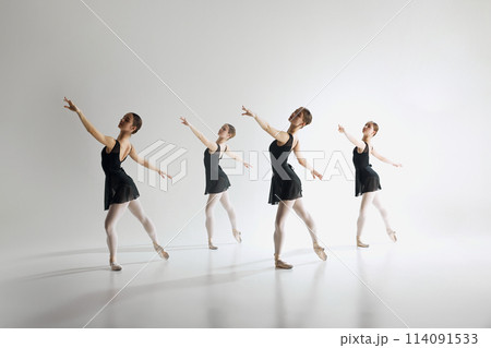 Beauty of ballet dance. Elegant teen girls, ballerinas in black leotards training, practicing against grey studio background. 114091533
