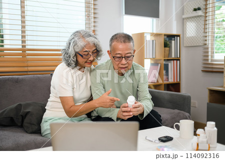 Senior couple having online appointment with doctor via laptop at home. Telemedicine concept Senior couple having online appointment with doctor via laptop at home. Telemedicine concept 114092316