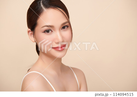 Beautiful young asian woman with clean fresh skin on beige background, Face care, Facial treatment, Cosmetology, beauty and spa, Asian women portrait. Beautiful young asian woman with clean fresh skin on beige background, Face care, Facial treatment, Cosmetology, beauty and spa, Asian women portrait. 114094515