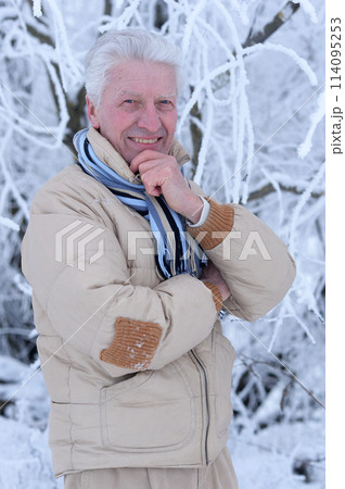 Portrait of senior man praying and posing in winter park 114095253