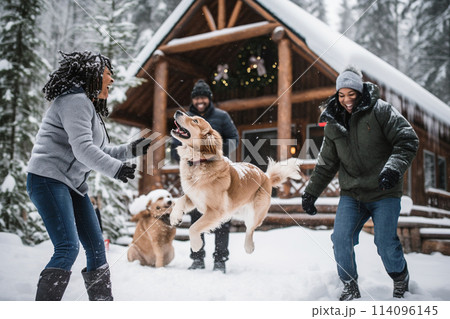 Two women and a golden retriever playing in the snow near a wooden cabin Two women and a golden retriever playing in the snow near a wooden cabin 114096145