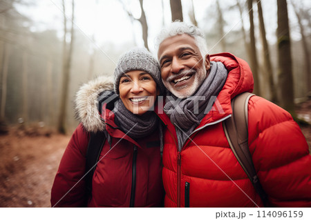Middle age mixed race couple enjoying outdoors activity in winter forest 114096159