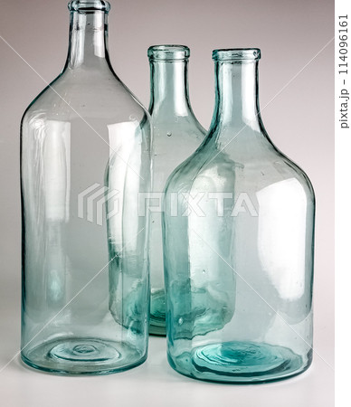 Empty old glass jars with a narrow neck for wine and spirits. Made in the USSR around 1930s 114096161