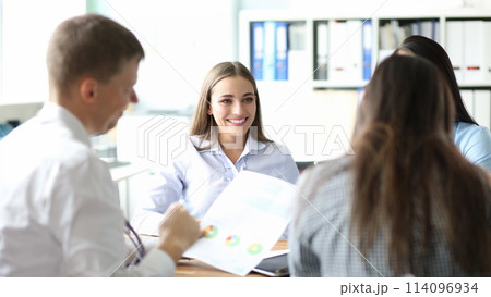 Smiling businesswoman portrait against business 114096934