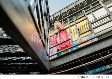 Happy cute child girl having fun outdoor in summer time. Children and generation alpha concept 114097955