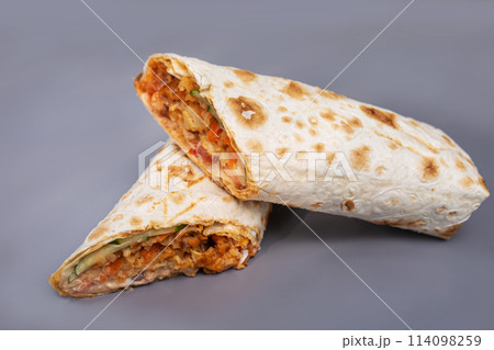 shaurma with chicken and vegetables on a gray background 114098259