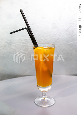 orange cocktail with black tube and orange orange cocktail with black tube and orange 114098265