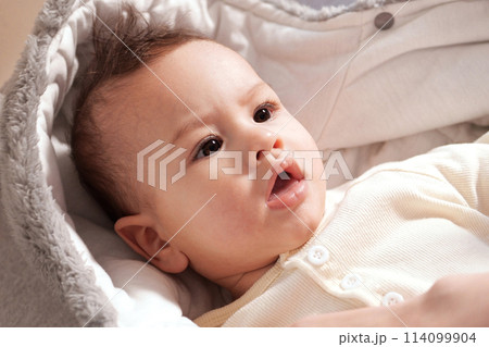 A mother dressing her little baby boy boy at home. childhood parenthood and growing up family concept real people 114099904