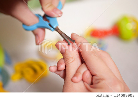 Cutting baby nails. Baby care, closed up shot of newborn nails clipping 114099905