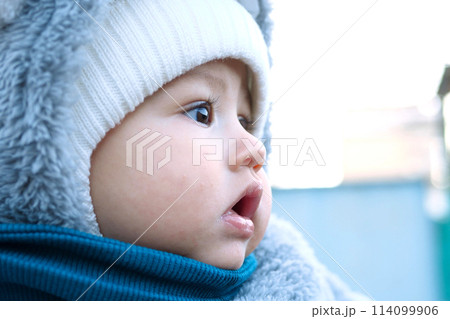 Happy little baby boy making outdoors in winter. Cute toddler in winter cloth. Child having fun on cold day. Winter walk outdoors 114099906