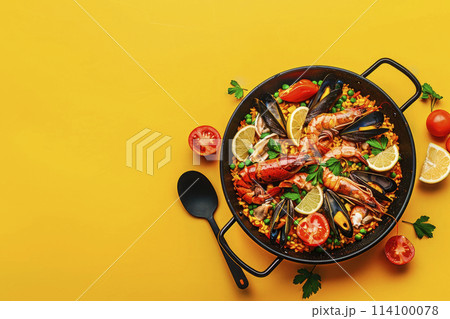 Traditional spanish seafood paella on yellow background. Top view. Copy space. Ai generative Traditional spanish seafood paella on yellow background. Top view. Copy space. Ai generative 114100078