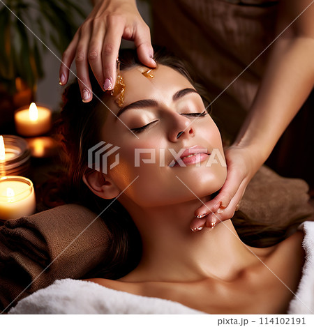 Soothing Rejuvenation: Closeup Portrait of a Woman Delighting in a Nourishing Oil Massage at a Spa 114102191