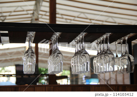 Crystal glasses upside down in the open air bar stock photo 114103412