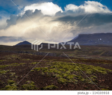 View during auto trip in West Iceland highlands, Snaefellsnes peninsula, Snaefellsjokull National Park. Spectacular volcanic tundra landscape with mountains, craters, lakes, gravel roads. 114103918