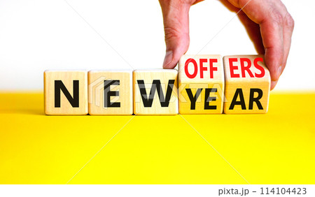 New year and offers symbol. Concept word New year New offers on beautiful wooden cubes. Beautiful yellow table white background. Businessman hand. Business new year and offers concept. Copy space. New year and offers symbol. Concept word New year New offers on beautiful wooden cubes. Beautiful yellow table white background. Businessman hand. Business new year and offers concept. Copy space. 114104423