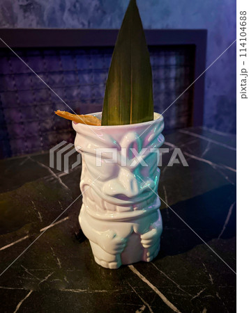 ceramic glass for cocktails in folk style with green palm leaf 114104688