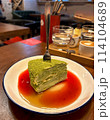 a piece of matcha cake with cranberry sauce 114104689