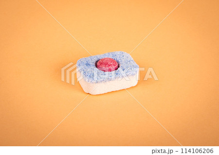 Dishwasher capsule on a light background. Housework and household appliances Dishwasher capsule on a light background. Housework and household appliances 114106206
